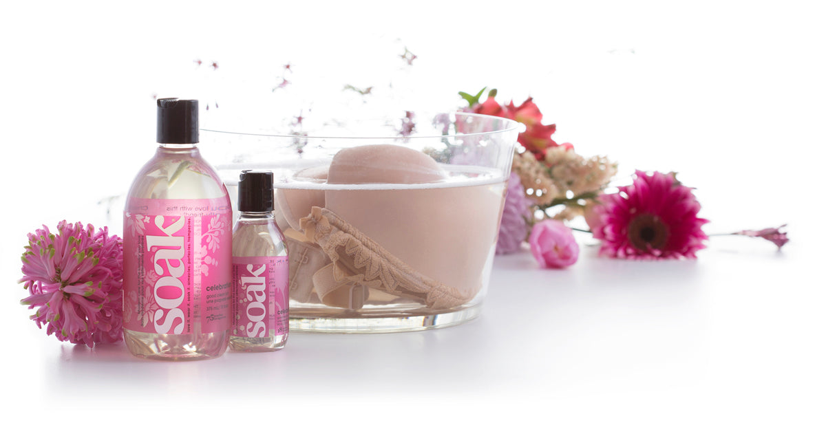Soak lingerie wash scent celebration with bra in wash tub surrounded by flowers